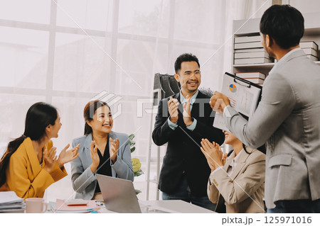 Group of Young Asian business team creative businesspeople coworker in office Happy to be successful partnership teamwork celebrating achievement and success concept. Group of Young Asian business team creative businesspeople coworker in office Happy to be successful partnership teamwork celebrating achievement and success concept. 125971016