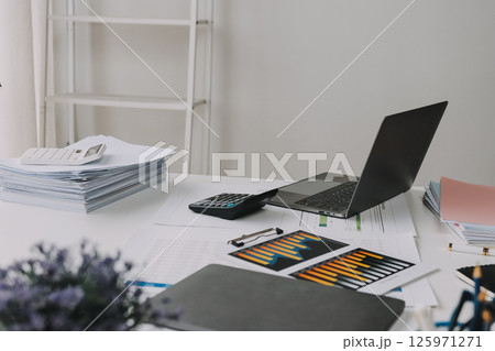 Team of financial advisory services. Asian advisor showing plan of investment to clients in the consultancy office. 125971271