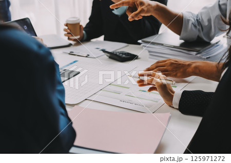 Team of financial advisory services. Asian advisor showing plan of investment to clients in the consultancy office. 125971272