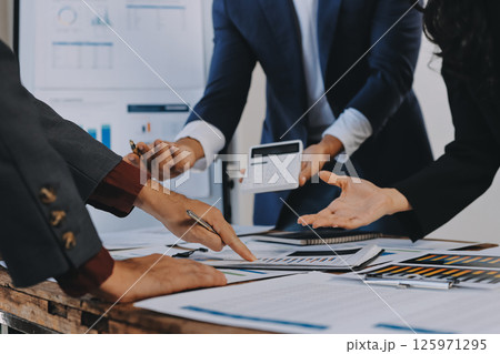 Accounting company provide finance and taxation planning for profitable cash flow, Auditor and accountant team working in office, analyze financial data and accounting record with calculator.Insight 125971295
