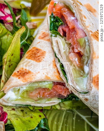 Fresh salad with tortilla wrap and a cup of mocha coffee — healthy lunch concept 125971329