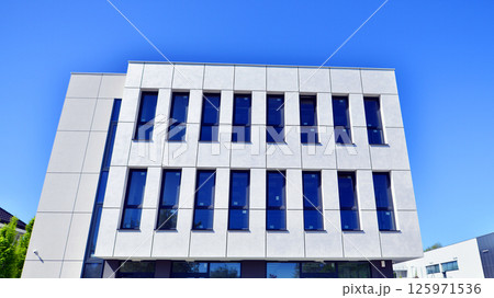 Modern office building with concrete facade and windows. Modern architectural details. Modern office building with concrete facade and windows. Modern architectural details. 125971536