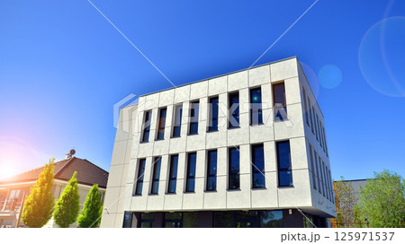 Modern office building with concrete facade and windows. Modern architectural details. 125971537