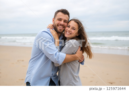 A couple hugging on the beach. 125971644