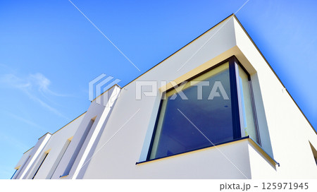 New single family houses in a new development area. Residential homes with modern facade. New single family houses in a new development area. Residential homes with modern facade. 125971945