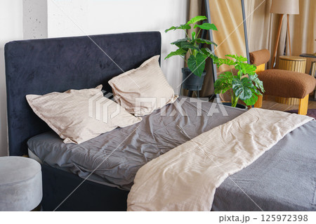 Cozy bedroom setting with pillows and cotton soft on black headboard background 125972398