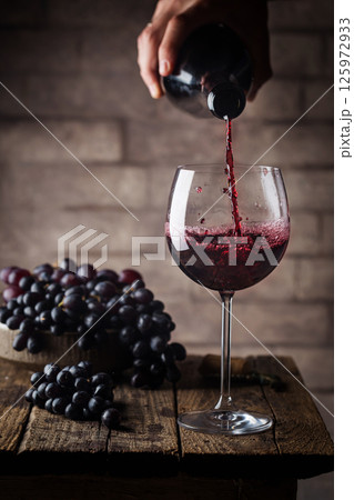 Pouring red wine 125972933