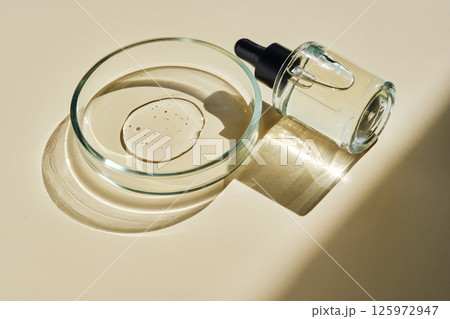 Facial serum with texture in a petri dish. Facial serum with texture in a petri dish. 125972947