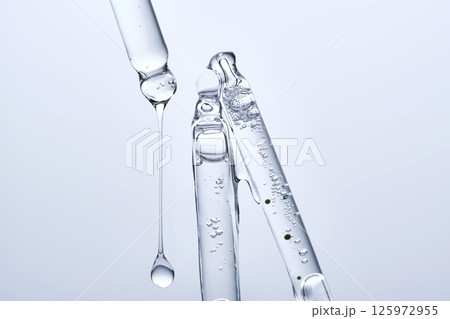 Three different face serum pipettes on a neutral background. Three different face serum pipettes on a neutral background. 125972955