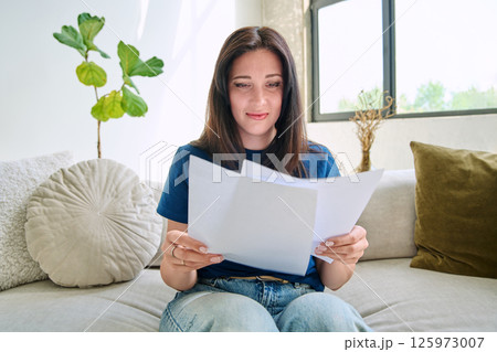 Webcam view young serious woman with business papers having video Webcam view young serious woman with business papers having video 125973007