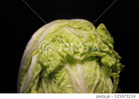 Top Part Of Napa Cabbage Head Isolated On Black Background. Head Of Peking Cabbage Isolated On Black Backdrop 125973214