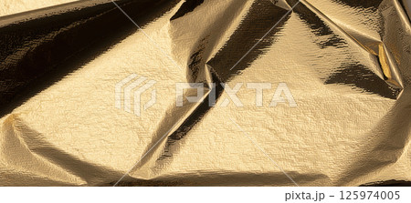 Golden foil sheet with reflective, shiny texture creates a chic, high-contrast design. Gold leaf 125974005
