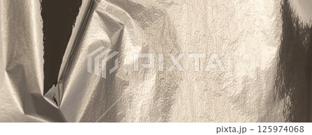 Silver foil with shiny, metallic texture creates a smooth, reflective surface. decor, and abstract Silver foil with shiny, metallic texture creates a smooth, reflective surface. decor, and abstract 125974068