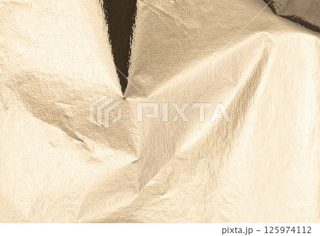 Gold foil texture with a crinkled, elegant finish. Reflective, luxury alloy sheet featuring a bright Gold foil texture with a crinkled, elegant finish. Reflective, luxury alloy sheet featuring a bright 125974112