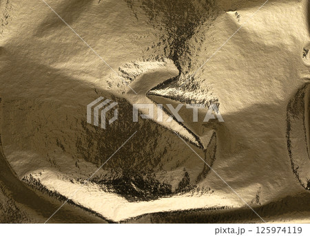 Gold foil texture with crumpled, folded metallic surface. Shiny, reflective background in rich Gold foil texture with crumpled, folded metallic surface. Shiny, reflective background in rich 125974119
