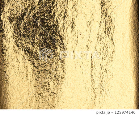 Gold metallic foil background. Shiny golden texture with reflective light, distressed finish, and 125974140