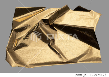 Golden foil sheet with reflective, shiny folds creating an opulent, modern design. Radiant gold leaf 125974173