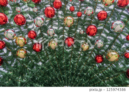 Colorful Christmas Ornaments Hanging on a Beautifully Decorated Tree Colorful Christmas Ornaments Hanging on a Beautifully Decorated Tree 125974386