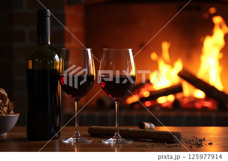 Wine and cigars by fireplace. 125977914