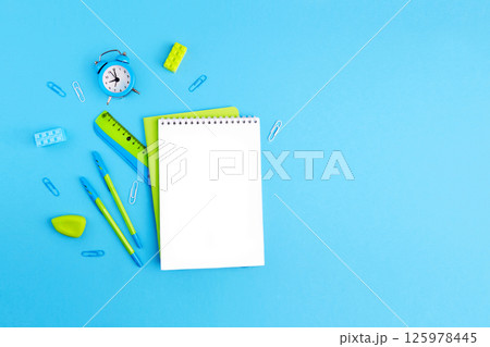 School supplies. Empty notebook, pens, ruler, alarm clock, paper clips School supplies. Empty notebook, pens, ruler, alarm clock, paper clips 125978445