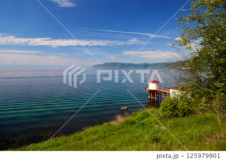 Lake Baikal on a summer day. Listvyanka village. Lake Baikal on a summer day. Listvyanka village. 125979901