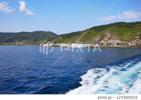 Lake Baikal on a summer day. View of the port from the ship to the port of Baikal Lake Baikal on a summer day. View of the port from the ship to the port of Baikal 125980028
