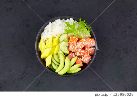 Hawaiian ahi, a diet meal with fish. Poke bowl of salmon, rice, avocado 125980029