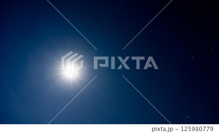 夜空を照らす月明かりと無数の輝く星 125980779