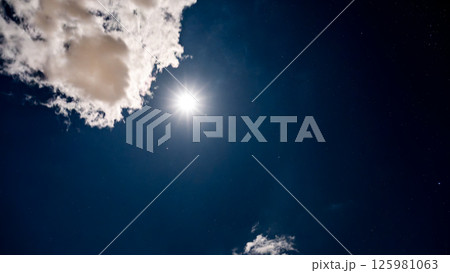 雲間に輝く満月と星空の夜空 125981063