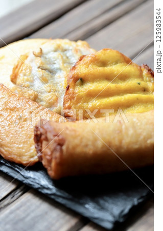 スレートプレートに乗せた色々な種類の揚げかまぼこ 125983544