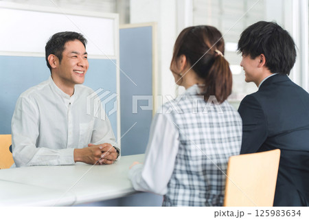 受付,商談をする男性客と男女のビジネスマン 125983634