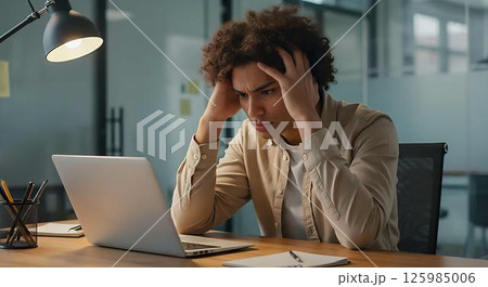 Frustrated businessman working late at night 125985006