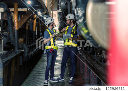 Engineer checking construction process railway and checking work on railroad station Engineer checking construction process railway and checking work on railroad station 125986211