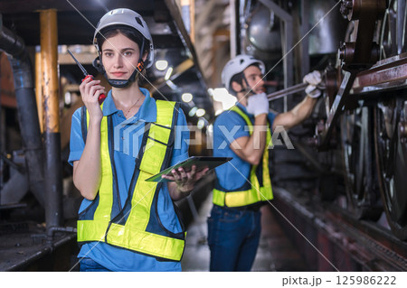 Engineer checking construction process railway and checking work on railroad station Engineer checking construction process railway and checking work on railroad station 125986222