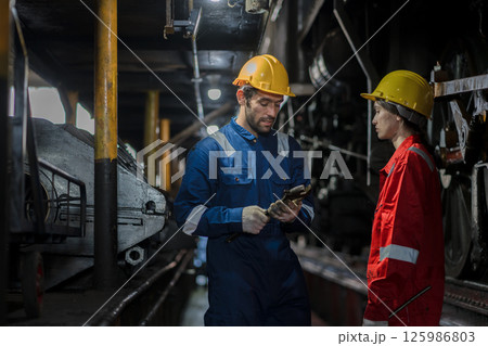 Engineer checking construction process railway and checking work on railroad station Engineer checking construction process railway and checking work on railroad station 125986803