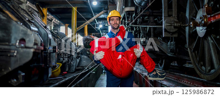 First aid support accident at work of worker at factory. Male worker has an accident on the floor in warehouse site. First aid support accident at work of worker at factory. Male worker has an accident on the floor in warehouse site. 125986872