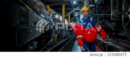 First aid support accident at work of worker at factory. Male worker has an accident on the floor in warehouse site. First aid support accident at work of worker at factory. Male worker has an accident on the floor in warehouse site. 125986875