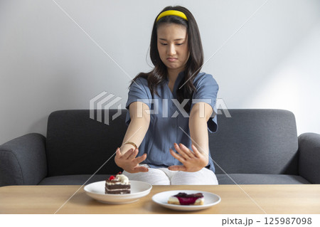 Beautiful Young Woman At Home Enjoying Cheesecake Dessert Beautiful Young Woman At Home Enjoying Cheesecake Dessert 125987098