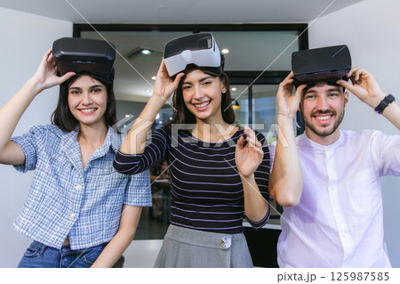 business persons with virtual reality headsets in meeting room at the office. business persons with virtual reality headsets in meeting room at the office. 125987585