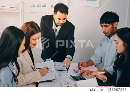 Team of financial advisory services. Asian advisor showing plan of investment to clients in the consultancy office. Team of financial advisory services. Asian advisor showing plan of investment to clients in the consultancy office. 125987853