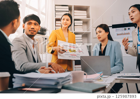 Team of financial advisory services. Asian advisor showing plan of investment to clients in the consultancy office. Team of financial advisory services. Asian advisor showing plan of investment to clients in the consultancy office. 125987893