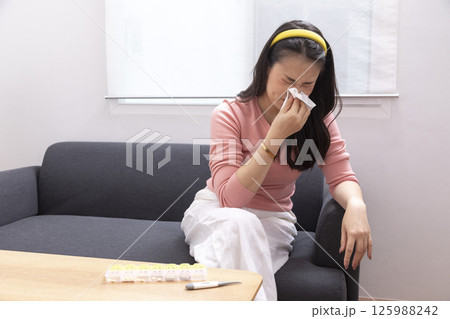 Sick Woman with Thermometer.Flu.Woman Caught Cold. Sneezing into Tissue. Headache.Virus. Sick Woman with Thermometer.Flu.Woman Caught Cold. Sneezing into Tissue. Headache.Virus. 125988242