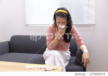 Sick Woman with Thermometer.Flu.Woman Caught Cold. Sneezing into Tissue. Headache.Virus. 125988243