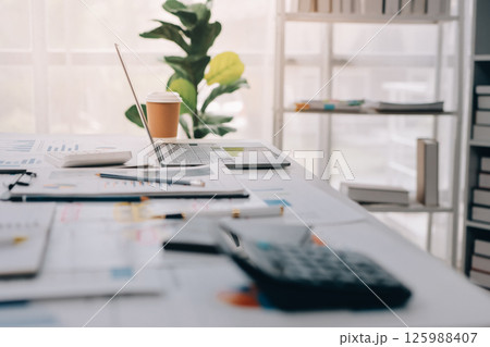 Team of financial advisory services. Asian advisor showing plan of investment to clients in the consultancy office. Team of financial advisory services. Asian advisor showing plan of investment to clients in the consultancy office. 125988407