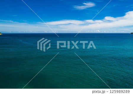Aerial view Top down seashore, Waves crashing on rocks cliff, Beautiful sea surface in sunny day summer background, Amazing seascape top view seacoast at Phuket Thailand 125989289