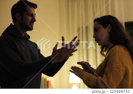 Married couple in emotional conflict and argument at home, fighting through relationship problems and difficult divorce discussions Married couple in emotional conflict and argument at home, fighting through relationship problems and difficult divorce discussions 125989732