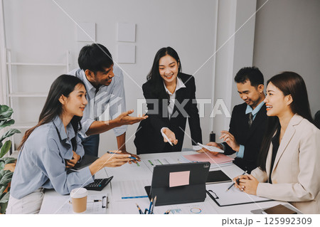 Team of financial advisory services. Asian advisor showing plan of investment to clients in the consultancy office. 125992309