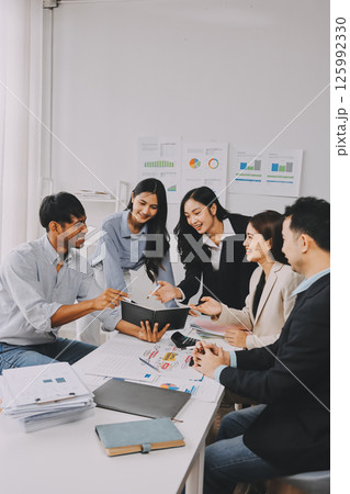 Team of financial advisory services. Asian advisor showing plan of investment to clients in the consultancy office. Team of financial advisory services. Asian advisor showing plan of investment to clients in the consultancy office. 125992330