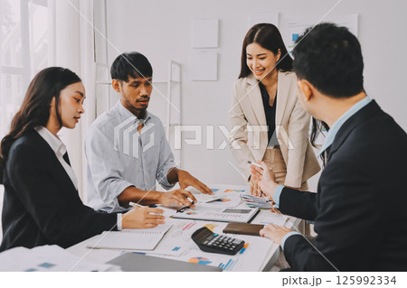 Team of financial advisory services. Asian advisor showing plan of investment to clients in the consultancy office. Team of financial advisory services. Asian advisor showing plan of investment to clients in the consultancy office. 125992334