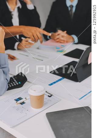 Team of financial advisory services. Asian advisor showing plan of investment to clients in the consultancy office. Team of financial advisory services. Asian advisor showing plan of investment to clients in the consultancy office. 125992915